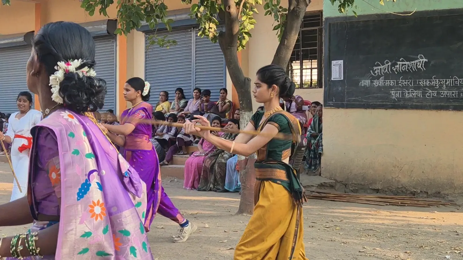 Girls in a close Lathi Kathi bout with guests watching in Shevgaon