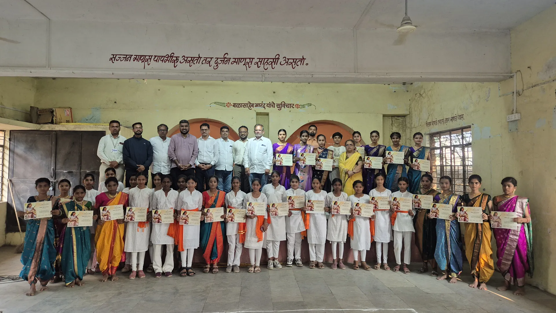 Girls holding their Lathi Kathi camp certificates with guests and teachers at Bharde Highschool, Shevgaon