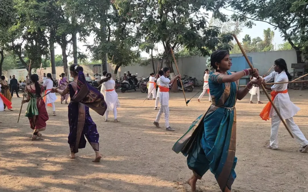 Girl in a saree practising a Lathi Kathi strike with her partner at Bharde Highschool, Shevgaon