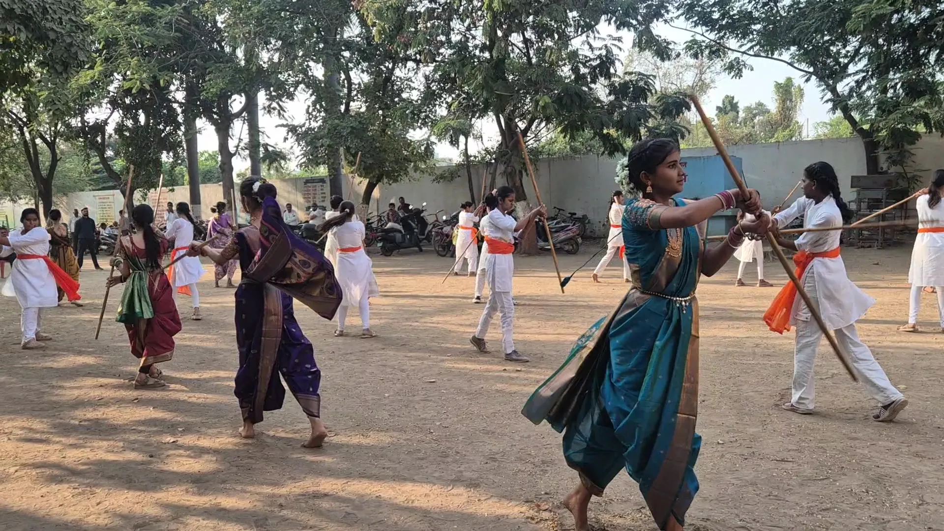 Girl in a saree practising a Lathi Kathi strike with her partner at Bharde Highschool, Shevgaon