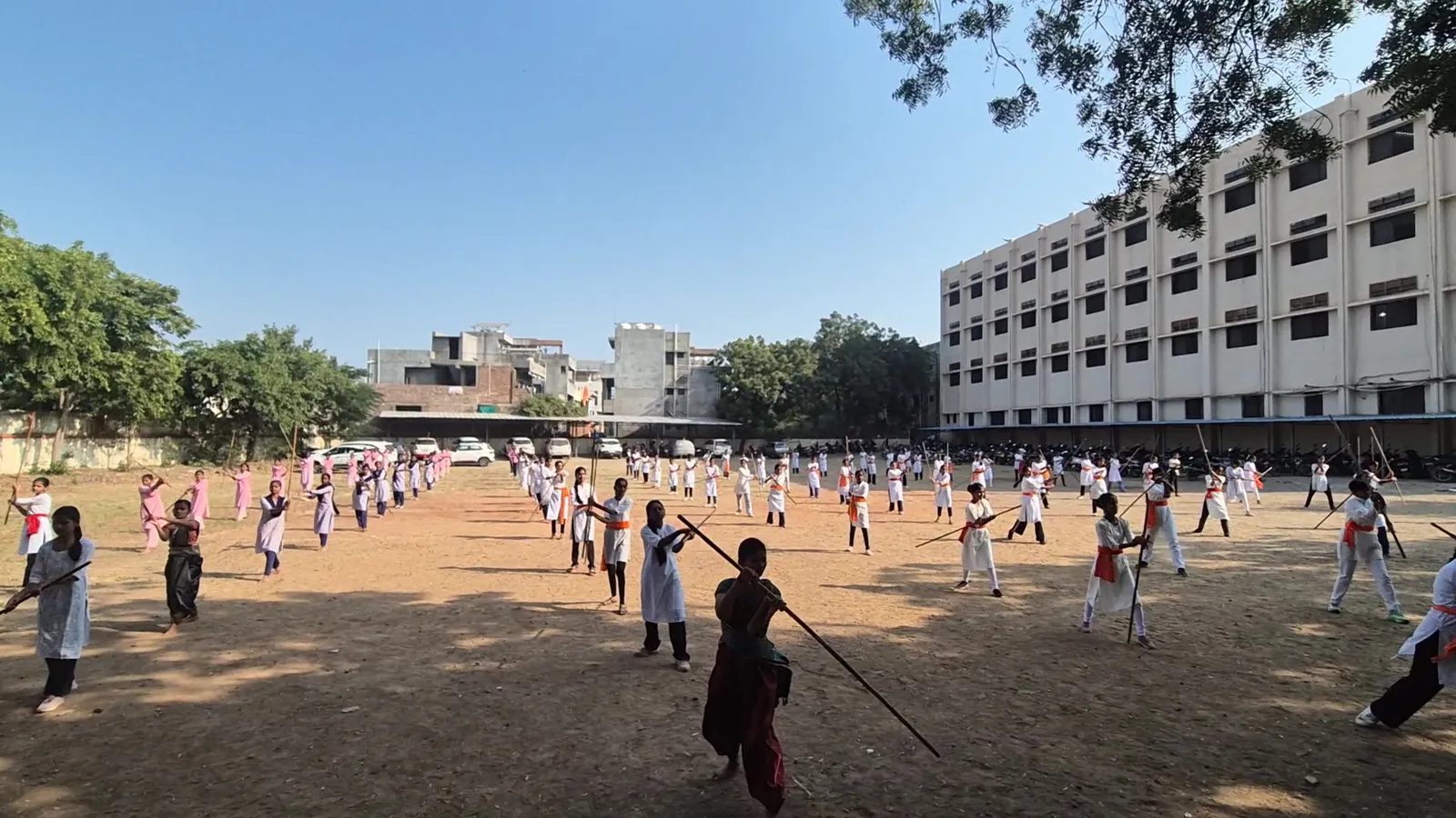 Girls practising Lathi Kathi across the ground at New Arts, Commerce and Science College, Shevgaon