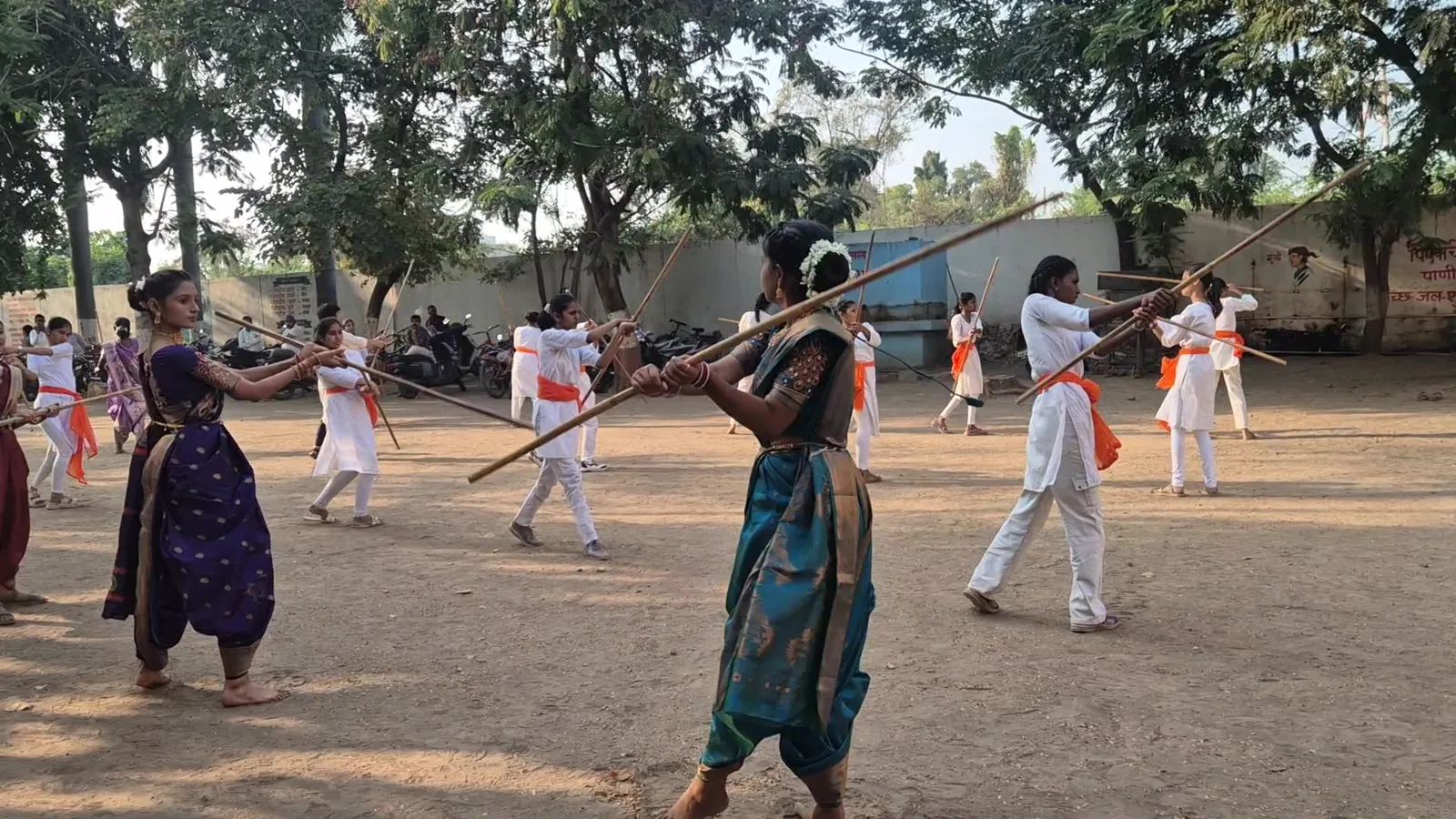 Pairs of girls sparring with lathis at Bharde Highschool, Shevgaon